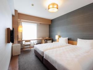 Cama ou camas em um quarto em Hotel Resol Trinity Hakata