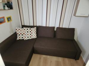 - un canapé brun avec deux oreillers dans l'établissement Traumblick, à Altenau