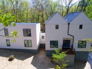 a large white house in the woods at The Getaway House ATL in Carrollton