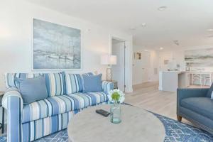 a living room with a blue couch and a table at Harbourtown Suites, Unit 211 in Plymouth
