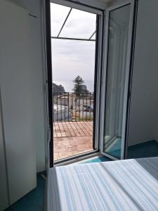 a room with a bed and a sliding glass door at L'Osservatorio - Luxury Guest House in Capri