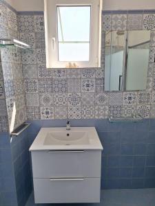 a bathroom with a white sink and a mirror at L'Osservatorio - Luxury Guest House in Capri +34 photos