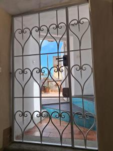 a door with a view of a pool through a gate at L'Osservatorio - Luxury Guest House in Capri