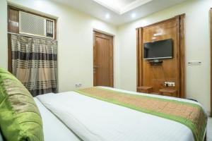 a hotel room with a bed and a tv at Hotel NK North Star " Foreign Guest Not Allowed " in New Delhi