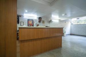 a man standing behind a counter in a kitchen at Hotel NK North Star " Foreign Guest Not Allowed " in New Delhi