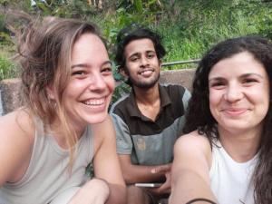 a man and two women sitting next to each other at Mountain View Home stay in Mirigama