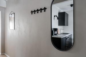 a bathroom with a mirror and a sink at Lovely Studio in Pispala in Tampere