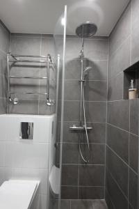 a bathroom with a shower and a sink at Urban Oasis - Two Bedrooms - Balcony - Nearby Metro in Helsinki