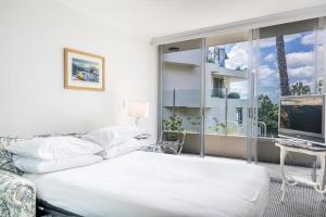 a bedroom with a bed and a large window at Gorgeous 2-Bed Unit near Riverside Parks in Sydney