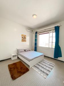 a bedroom with a large bed and a window at Ideal F3 in Dakar