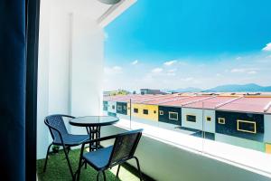 a table and two chairs on a balcony with a view at Manhattan Condominium Ipoh in Ipoh