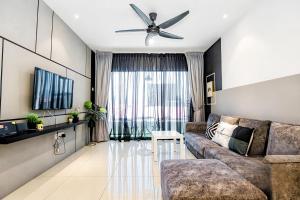 a living room with a couch and a ceiling fan at Manhattan Condominium Ipoh in Ipoh