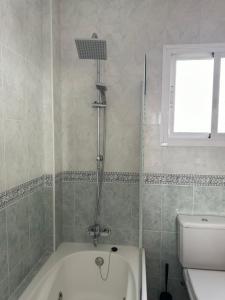 a bathroom with a shower and a bath tub at Habitacion 801 in Estepona