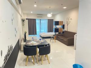 a living room with a table and a couch at Summer suites klcc by Peaceful Nest in Kuala Lumpur