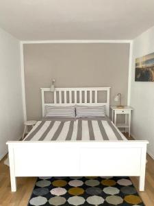 a large white bed in a room with two tables at NEU! Moderne Fewo Schieke in Schleiz