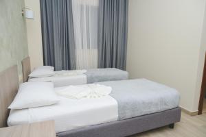 Postel nebo postele na pokoji v ubytování IPN ROOMs