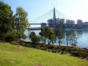 een uitzicht op een brug over een rivier met een park bij Cute Heritage Home with Balcony close to the City in Sydney