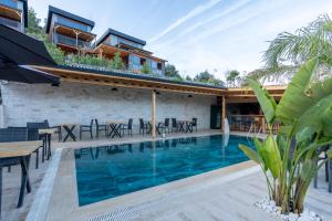 a house with a swimming pool and a patio at La Veranda Villas in Kumluca