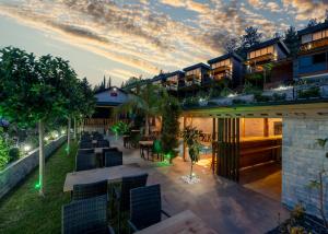 an outdoor patio with tables and chairs at dusk at La Veranda Villas in Kumluca