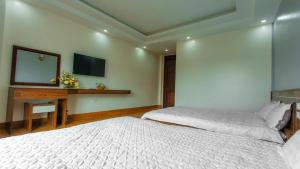 Postel nebo postele na pokoji v ubytování PHÚC HƯNG HOTEL
