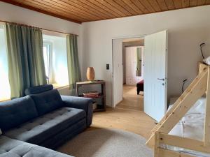 a living room with a couch and a staircase at Ferienhaus Frieda 