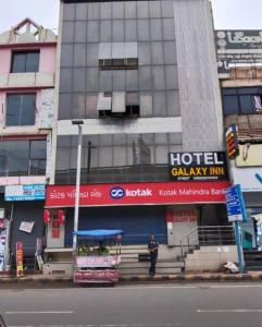 a man standing in front of a hotel galaxy inn at Galaxy Inn Hotel in Ahmedabad
