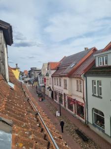 a person walking down a street next to buildings at Pärnu Old Town apartment in Pärnu
