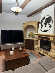 a living room with a fireplace and a flat screen tv at Habitacion 801 in Estepona