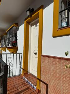 a front door of a house with yellow accents at Habitacion 801 in Estepona