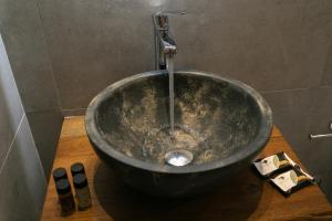 a bathroom with a sink with a faucet in a bathroom at Gaia Apartment II in Parga