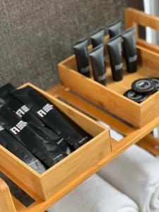 a wooden tray filled with black video game controllers at Azumi Boutique Hotel in Manila