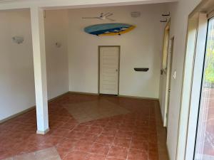 a hallway with a door and a tiled floor at Farnborough Stay in Yeppoon