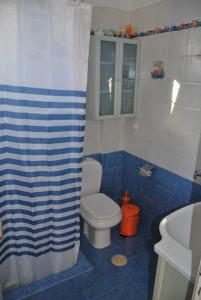 un bagno bianco e blu con servizi igienici e lavandino di πολυτελής εξοχική κατοικία a Nea Makri