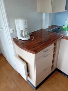 a kitchen counter with a mixer on top of it at mobilhome 5 couchages in Nages
