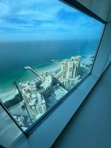 a view from a window of a building at F30,R3,Sunrise on the beach,1room inside 3bedroom apartment,(separate washroom outside) in Ajman 
