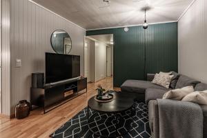 a living room with a couch and a tv at Longyearbyen Apartment in Longyearbyen