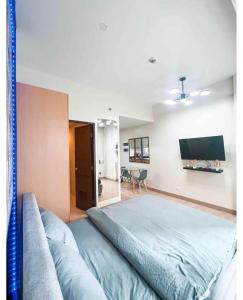 um quarto com uma cama grande e uma televisão de ecrã plano em Lafayette Park Square Megaworld em Iloilo