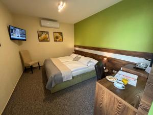 a hotel room with a bed and a table at Hotel Garni Expo in Banská Bystrica