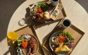 a table with two plates of food on it at Square 8 HAKUBA RETREAT by UNPLAN in Hakuba