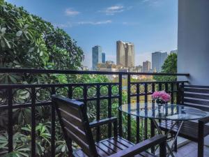 a table and chairs on a balcony with a view of the city at Sunshine Hotel in Phnom Penh
