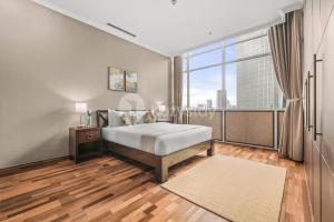 a bedroom with a bed and a large window at Soka by Kozystay - Mega Kuningan in Jakarta +30 photos