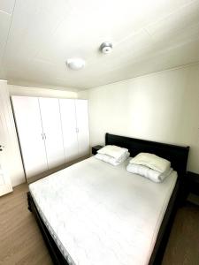 a bedroom with a large bed with two pillows at Longyearbyen Apartment in Longyearbyen