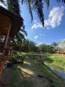 a view of the yard of a resort with palm trees at Lak Kao Nai Resort in Ban Pha Saeng Lang +5 photos