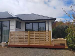 a house with a wooden deck in front of it at Cashmere B&B in Masterton