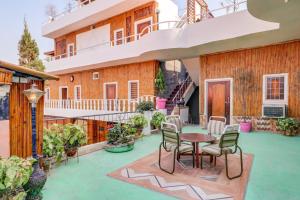 an outdoor patio with a table and chairs at Hotel O Shanti Kuti Home Stay in Lucknow