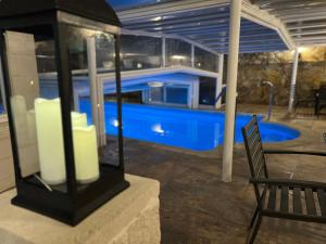 a swimming pool with a bench and a chair at Hotel Don Diego in Suances