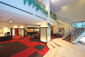 a lobby with a staircase in a building at Chisun Hotel Hamamatsucho in Tokyo