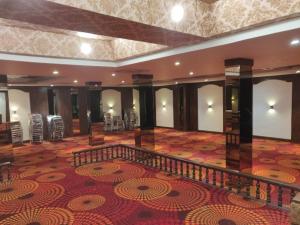 a large room with a carpeted floor and a staircase at Hotel Vinayak Palace Telipara in Bilāspur