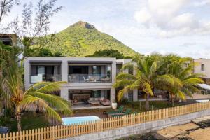 a house with a mountain in the background at Tamarin Sunset Beach V in Tamarin