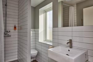 a bathroom with a sink and a toilet at Midgard Base Camp in Hvolsvöllur